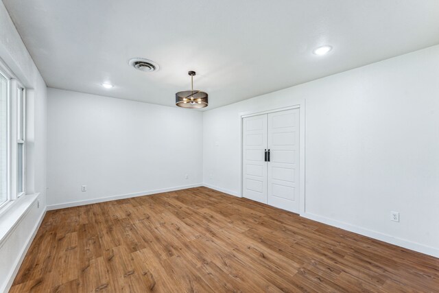 empty room featuring hardwood / wood-style floors and a wealth of natural light