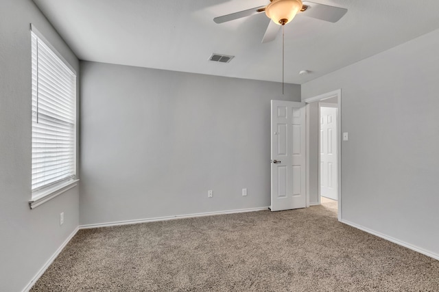 carpeted empty room featuring ceiling fan