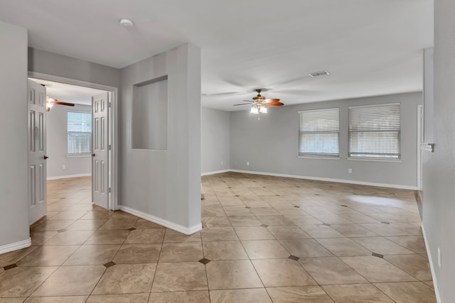 unfurnished room featuring ceiling fan and light tile patterned flooring