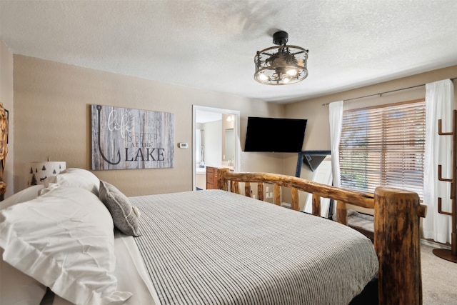 bedroom featuring a textured ceiling and carpet floors