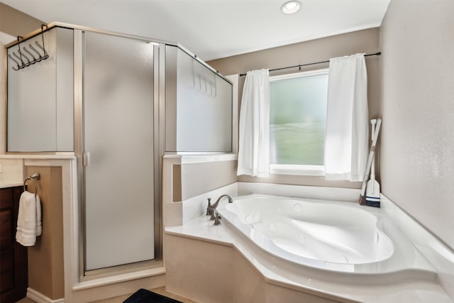 bathroom with separate shower and tub