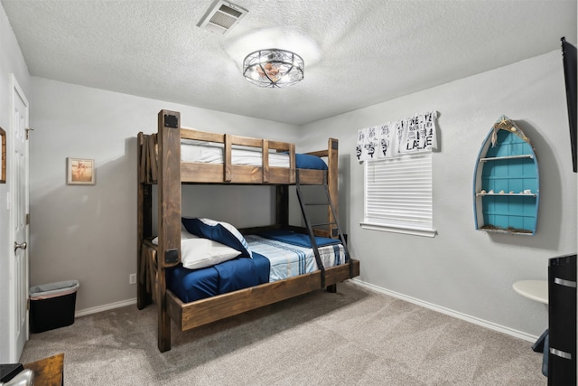 carpeted bedroom featuring a textured ceiling