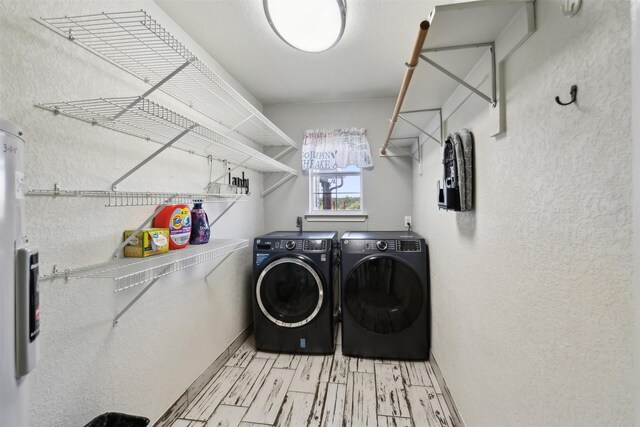 laundry room featuring light wood-type flooring and washing machine and clothes dryer