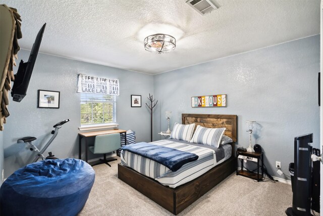 carpeted bedroom with a textured ceiling