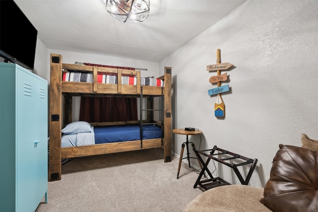 carpeted bedroom featuring a textured ceiling