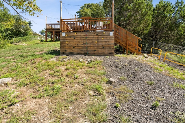 view of yard with stairway, a wooden deck, and fence