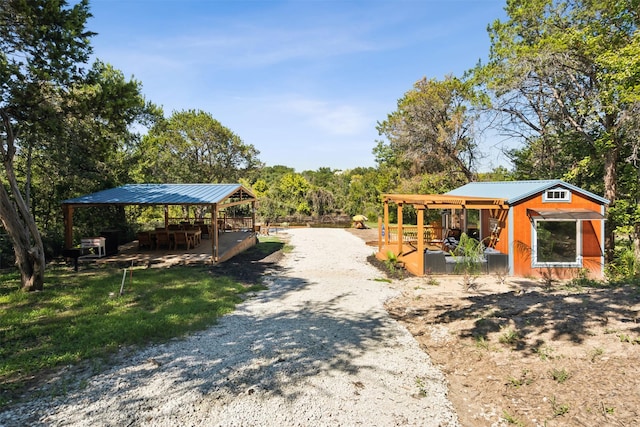 view of community featuring gravel driveway