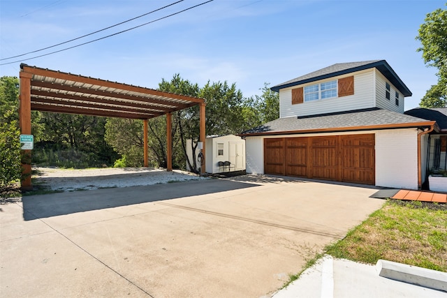 view of front facade featuring a garage and a storage shed