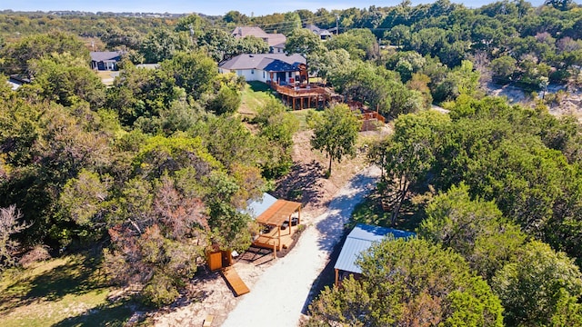 birds eye view of property with a view of trees