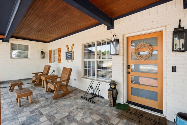 doorway to property featuring brick siding