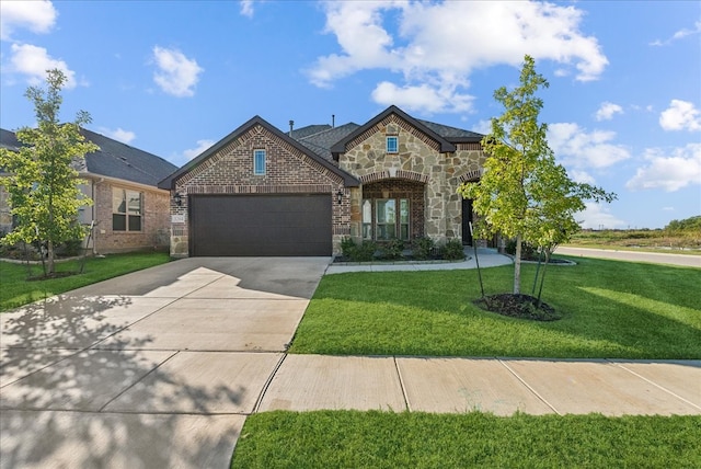 view of front of home with a garage and a front lawn