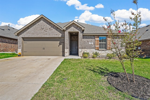 view of front of property with a garage and a front yard