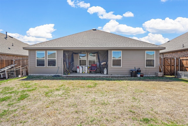 rear view of property featuring a lawn and a patio