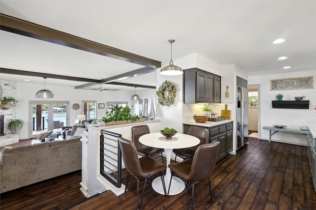 dining room featuring french doors, dark hardwood / wood-style floors, beam ceiling, and ceiling fan