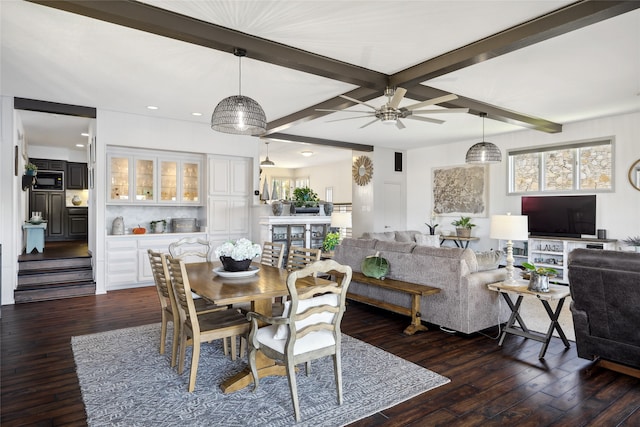 dining room featuring beamed ceiling, ceiling fan, and dark hardwood / wood-style floors