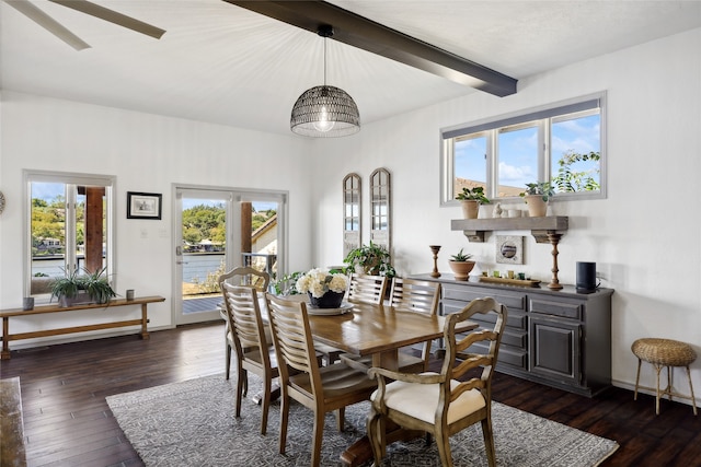 dining space featuring dark wood-type flooring and beamed ceiling