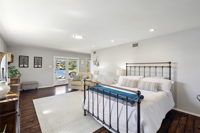 bedroom with access to exterior and dark wood-type flooring