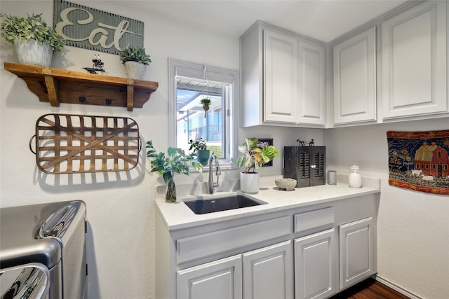 kitchen with dark wood-type flooring, sink, and white cabinets