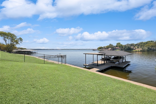 view of dock featuring a water view and a yard