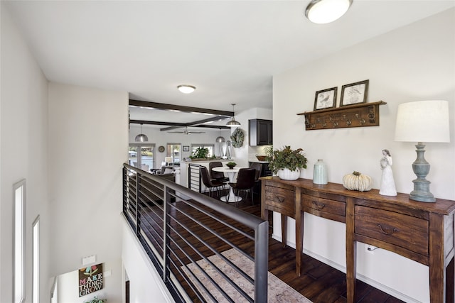 corridor with beamed ceiling and dark hardwood / wood-style flooring