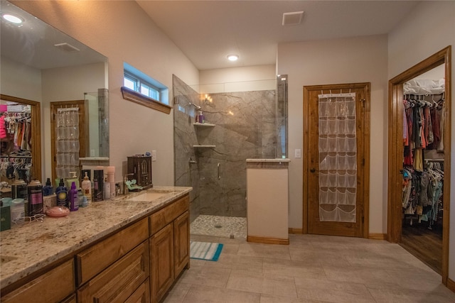 bathroom featuring vanity, tile patterned floors, and walk in shower