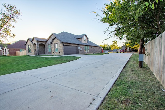 view of front of property with a yard and a garage