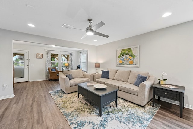 living room featuring hardwood / wood-style floors and ceiling fan