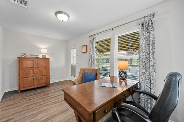 office space with light hardwood / wood-style floors