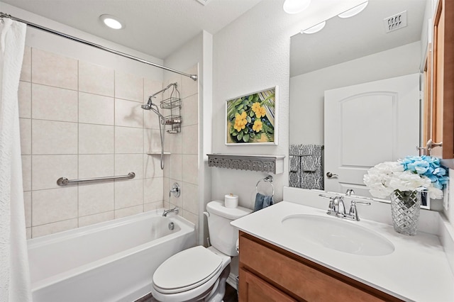 full bathroom featuring vanity, toilet, and shower / tub combo