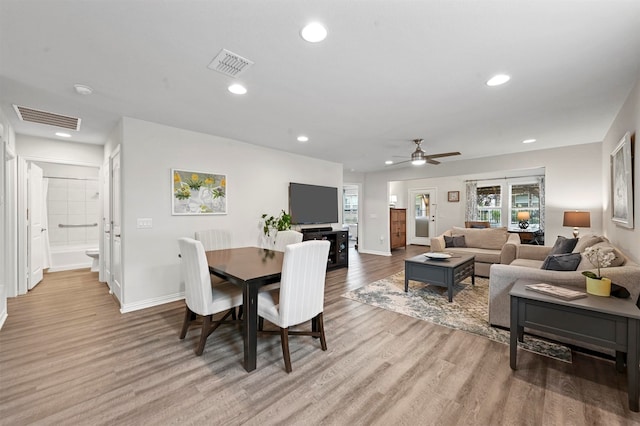 dining space featuring light wood-type flooring and ceiling fan