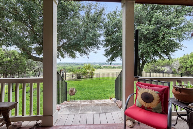 wooden deck featuring a yard and a rural view