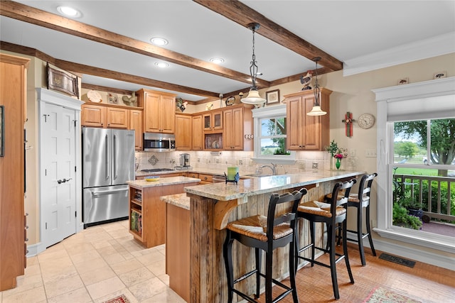 kitchen featuring backsplash, light stone countertops, stainless steel appliances, kitchen peninsula, and a kitchen breakfast bar