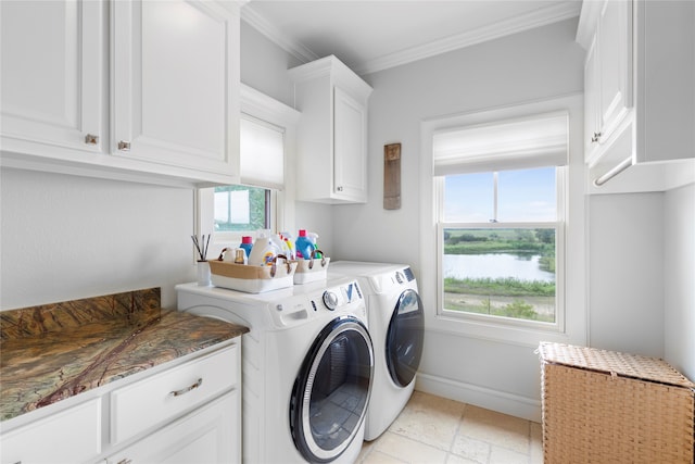 laundry room with light tile patterned floors, washing machine and clothes dryer, cabinets, and ornamental molding