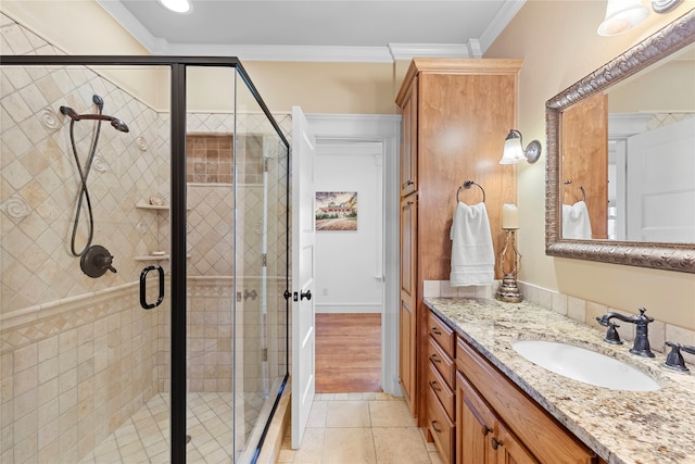 bathroom featuring crown molding, vanity, hardwood / wood-style flooring, and an enclosed shower