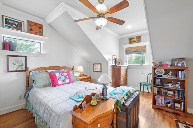 bedroom with lofted ceiling, ceiling fan, hardwood / wood-style flooring, and crown molding