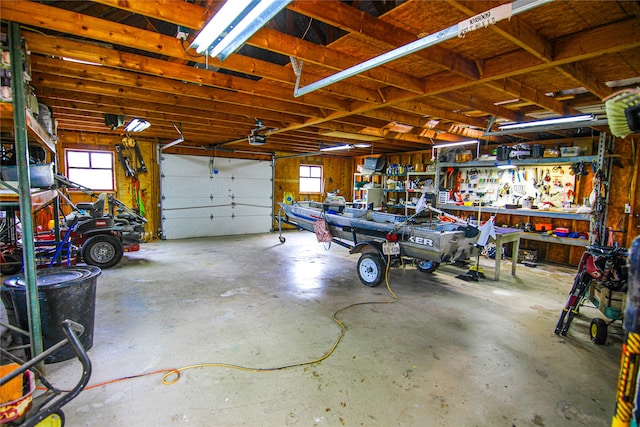 garage featuring a garage door opener and a workshop area