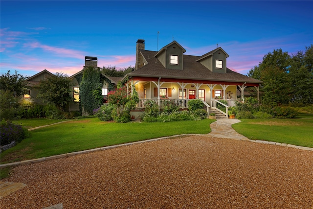 view of front of house with a yard and covered porch