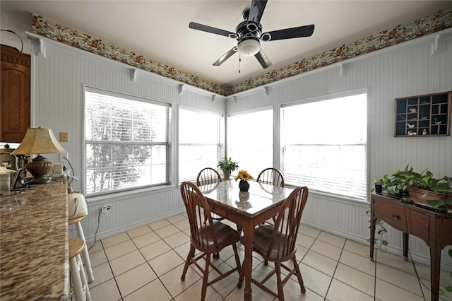 dining space with light tile patterned floors and ceiling fan