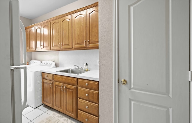 interior space with cabinets, separate washer and dryer, sink, and light tile patterned floors