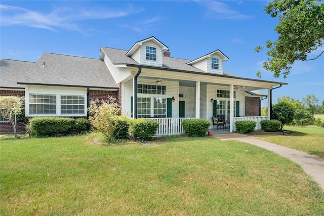 cape cod home with a porch and a front lawn