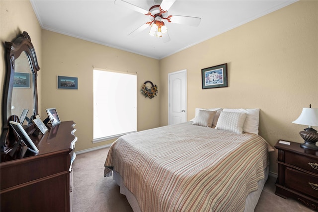 bedroom featuring crown molding, light colored carpet, and ceiling fan