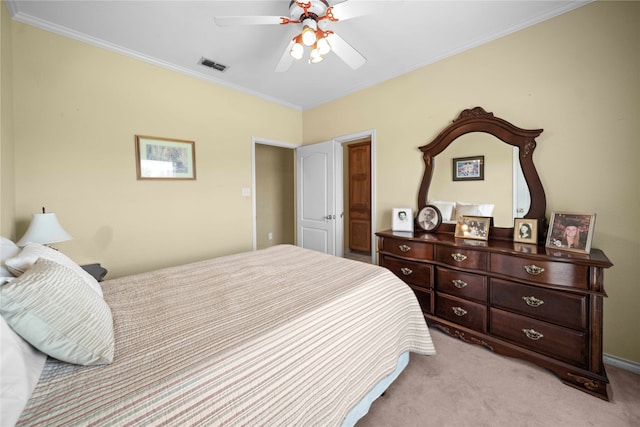 bedroom with ceiling fan, light colored carpet, and crown molding