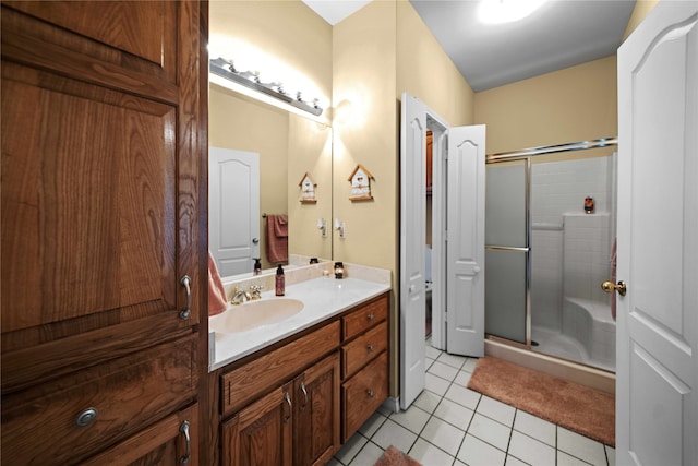 bathroom with vanity, an enclosed shower, and tile patterned flooring