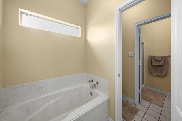 bathroom with a bathing tub and tile patterned floors