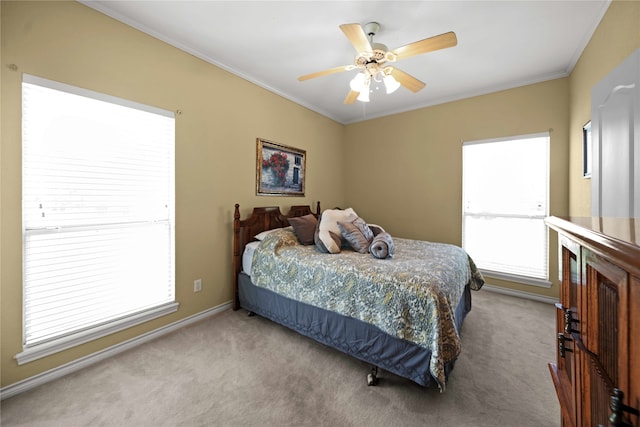 carpeted bedroom with ceiling fan, ornamental molding, and multiple windows