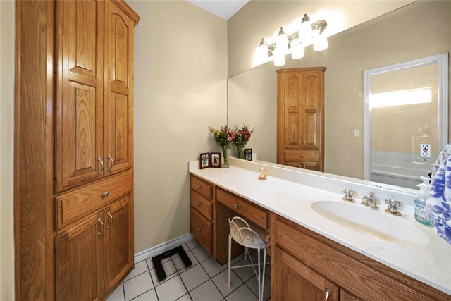 bathroom with vanity, a bathing tub, and tile patterned flooring