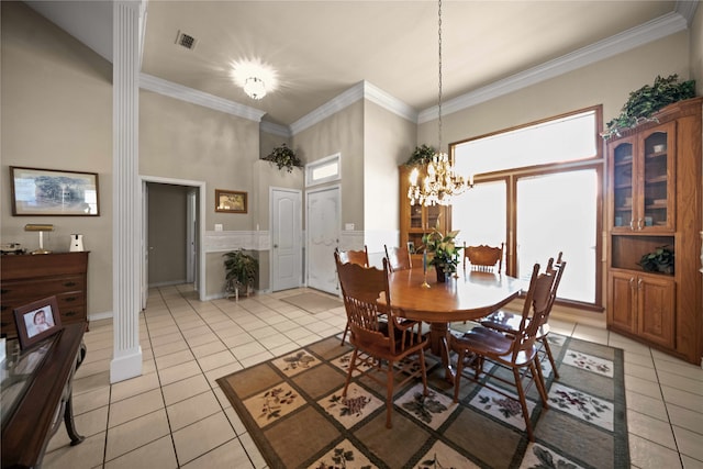 dining area with ornamental molding, a healthy amount of sunlight, a chandelier, and light tile patterned flooring