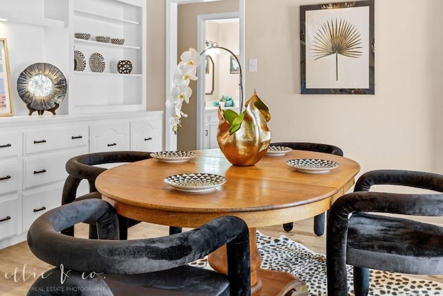 dining space with wood-type flooring