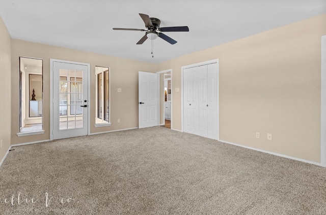 empty room with ceiling fan and carpet