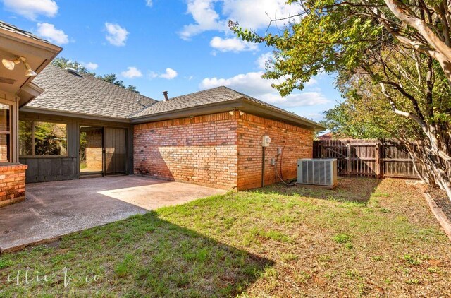 view of yard with a patio area and central AC